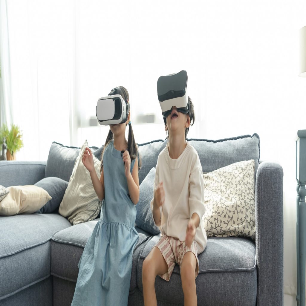 Asian child feeling excited while using 360 VR headset for virtual reality, Metaverse at home.